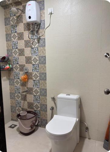 a bathroom with a white toilet in a room at Staymisty igatpuri in Igatpuri