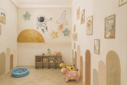 a childs room with a wall with astronaut and stars at Solia Villa in Da Nang