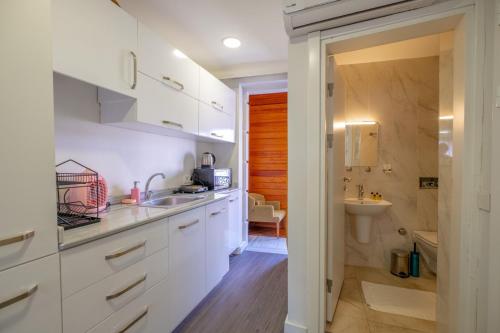 a kitchen with white cabinets and a sink at Sophia Hotel Oldcity in Istanbul