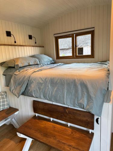 a bed in a small room with a window at The Shepherds Rest in East Dean