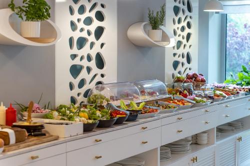 a buffet with a lot of food on display at Hotel Aqua Sopot - Destigo Hotels in Sopot