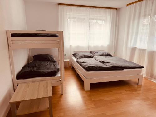 a bedroom with two bunk beds and a window at FeWo Haus 9 EUROPA PARK RULANTICA in Lahr