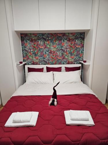 a dog is sitting on a large bed at Rubin Stay-Karabas Apartments in Vicenza