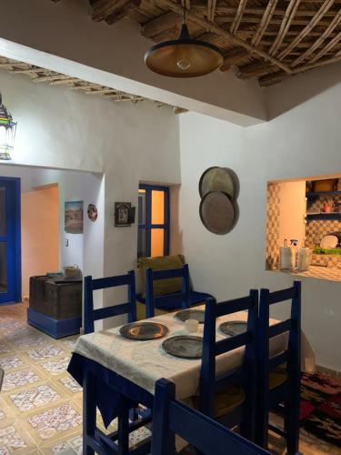 a dining room with a table and chairs at Chez Youssef in Merzouga