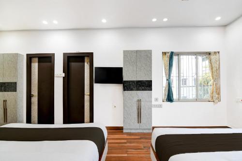 Salt Lake CityHotel O Aditi Guest House的有两张床和一扇窗户的卧室