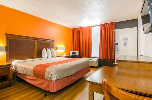 a hotel room with a bed and a table at Motel 6-Conyers, GA in Conyers