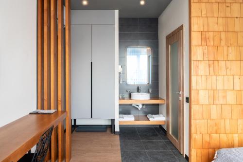 a bathroom with a sink and a mirror at Bukville Hotel & SPA in Bukovel