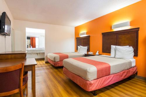 a hotel room with two beds and a desk at Motel 6-Conyers, GA in Conyers
