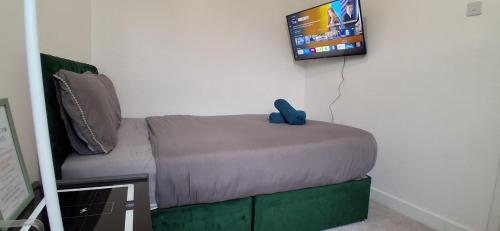 a couch with a teddy bear sitting on top of it at Room in Portsmouth in Portsmouth
