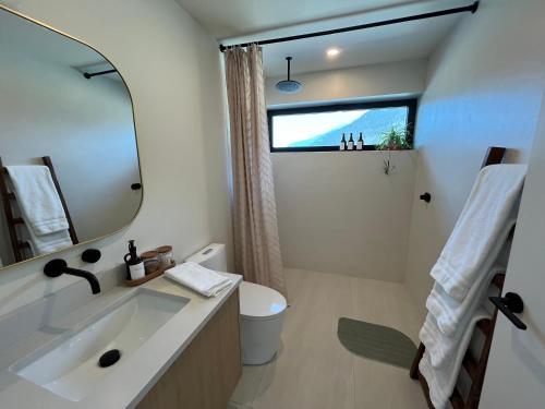 een badkamer met een wastafel en een spiegel bij 2BR, Views, Spacious, Luxury, New Home in Whistler