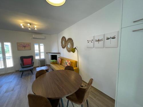 a dining room with a wooden table and chairs at Las Calas departamento ideal! in Sotillo de la Adrada