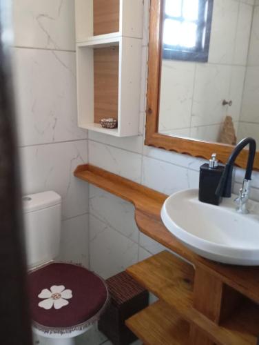 a bathroom with a sink and a toilet at Casa de praia in Arroio do Sal