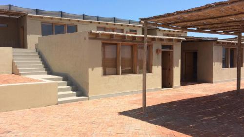 una casa con scale e un edificio di Puemape Surf Camp a Puémape