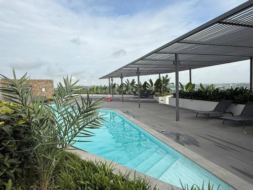 a swimming pool on the roof of a building at East Legon Loxwood House Condo with Gym & Pool in Accra