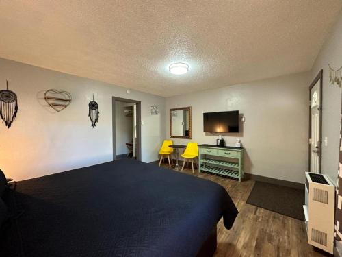 a bedroom with a bed and a desk with two yellow chairs at Lake Ridge South Lake Tahoe in South Lake Tahoe