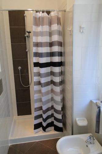 a bathroom with a shower curtain and a sink at lecasedimarco2 in La Spezia