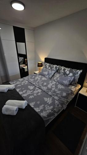 a bedroom with a bed with towels on it at Stan na dan Jović in Modriča