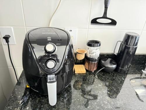 a coffee maker on a counter in a kitchen at Cozy apartment near the airport in São José dos Pinhais