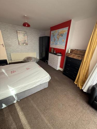 a bedroom with a bed and a dresser in it at spacious King bed 30FT Room in Kenton