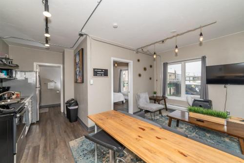 a living room with a wooden table and a kitchen at Downtown 2 Bedroom Apartment - Free Parking in Appleton