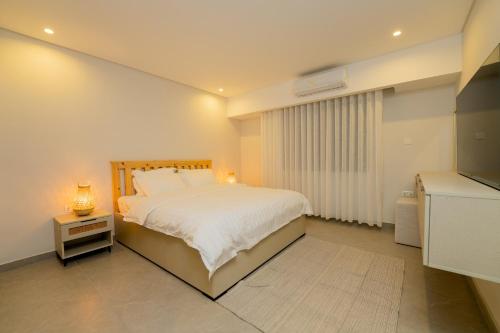 En eller flere senge i et værelse på Maria Suites 1