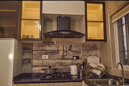 a kitchen with a sink and a stove top oven at 3M-Z Lekki Luxury Shortlet Duplex Apartment in Mama