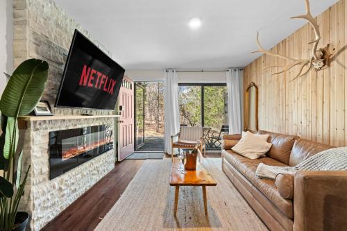 a living room with a couch and a fireplace at Ski In Ski Out Cabin on Hunter Mtn Seasonal Pool Access w Panoramic Views Hike Swim Fish Relax in Lanesville