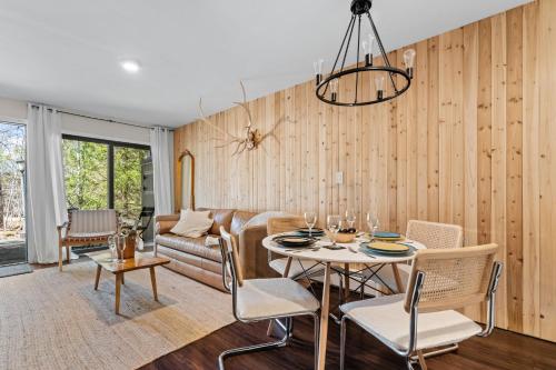 a living room with a table and a couch at Ski In Ski Out Cabin on Hunter Mtn Seasonal Pool Access w Panoramic Views Hike Swim Fish Relax in Lanesville
