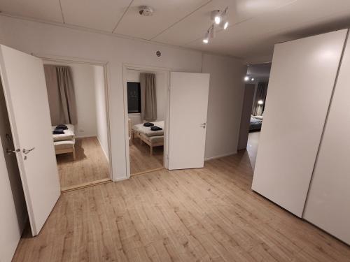 an empty room with a bed and a mirror at Arctic Aurora Villa with a Lappish Grill Hut - Northern Lights and Private Sledding Hill in the Backyard, in the Hometown of Santa Claus, Rovaniemi in Rovaniemi