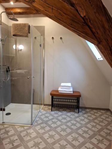 a bathroom with a shower and a bench at Gästehaus Grüner Baum in Oestrich-Winkel