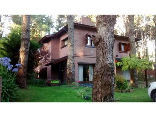 a house with trees in front of it at okin 11 flores in Costa del Este