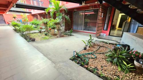 a courtyard of a house with a bunch of plants at kodus hotel boutique in Pattaya South