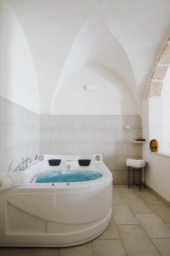 a large white bath tub in a room at BED&BREAD Piazza 'Nzegna in Carovigno