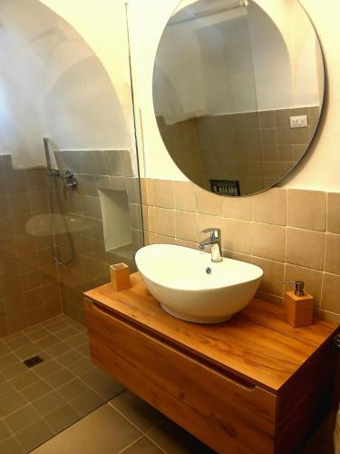 a bathroom with a sink and a mirror at Trulli Donna Grazia in Martina Franca