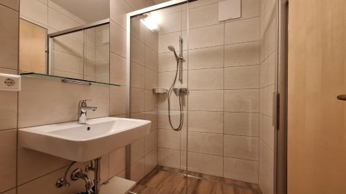 a bathroom with a sink and a shower at Haus König in Mauterndorf