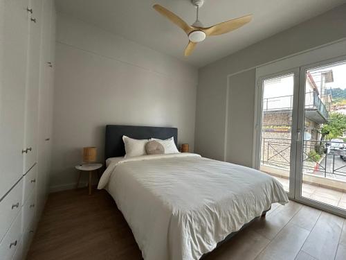 a bedroom with a bed and a ceiling fan at Karpenisi Nest in Karpenisi