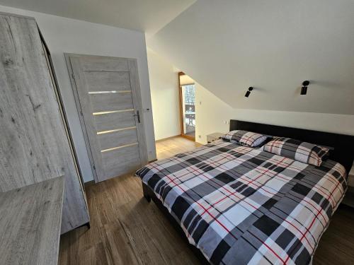 Ένα ή περισσότερα κρεβάτια σε δωμάτιο στο Osada u Pogwizdów