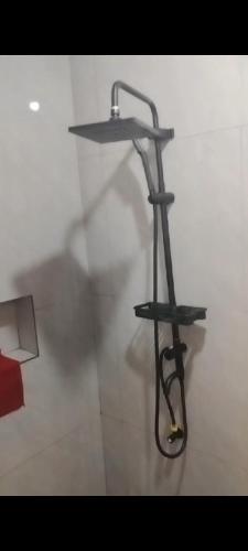 a shelf with a hose on a wall at Auntie's in Tanza