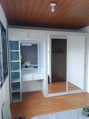 a room with a sliding glass door with a bedroom at Auntie's in Tanza