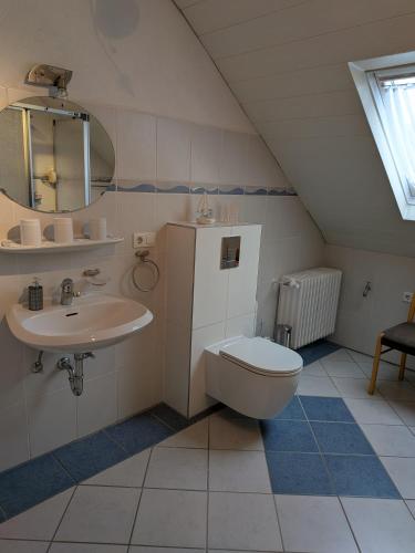 a bathroom with a toilet and a sink at Eifel-FeWo by Eva Kröll in Manderscheid