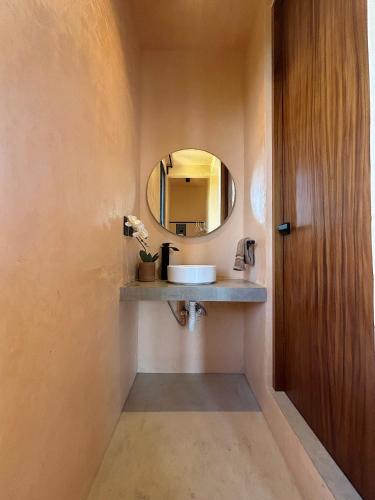 a bathroom with a sink and a mirror at Casa Melon 1BR Spectacular Private Oceanview Terrace in Santa María Colotepec