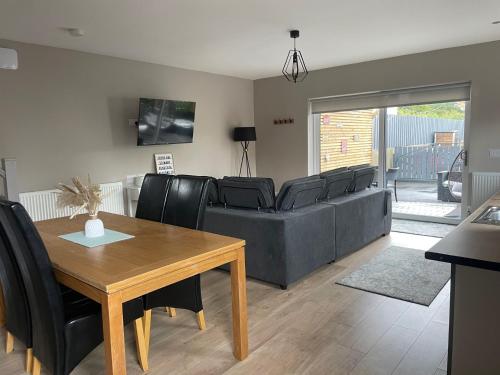 a living room with a couch and a table at The Nest in Newry