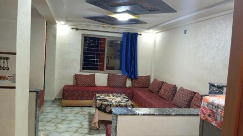 a living room with a couch and a table at Dar Bouchikhi in Moulay Yacoub