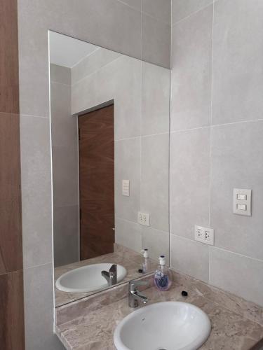 a bathroom with a sink and a mirror at Sur Backpackers in Santa Cruz de la Sierra