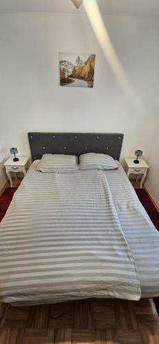 a large bed in a bedroom with two night stands at Vikendica Kod Koje in Banja Luka
