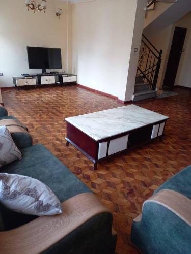 un soggiorno con due divani e una TV a schermo piatto di Guest house ad Addis Abeba