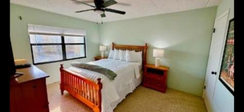 Ocean Terrace في Daytona Beach Shores: غرفة نوم بها سرير ومروحة سقف