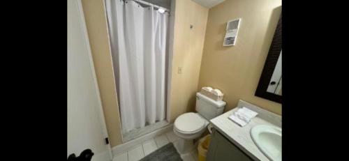 Ocean Terrace في Daytona Beach Shores: حمام مع مرحاض ومغسلة ونافذة