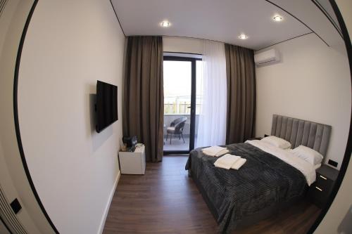 a bedroom with a bed and a mirror at Davos Hotel in Pʼarakʼar