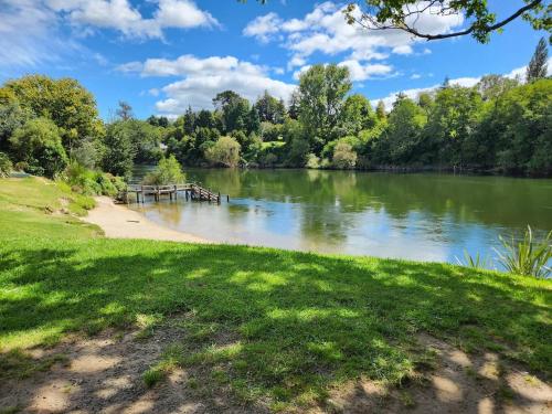 a view of a lake with a dock at The Orange Cottage in Hamilton